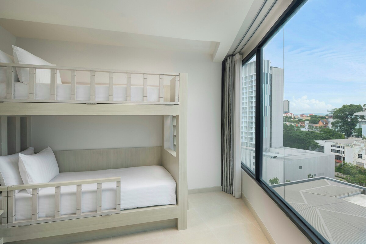 A bunk bed room with a city view.
