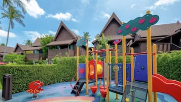 Children can play on colorful play structures with a slide and climbing elements set on a play mat.