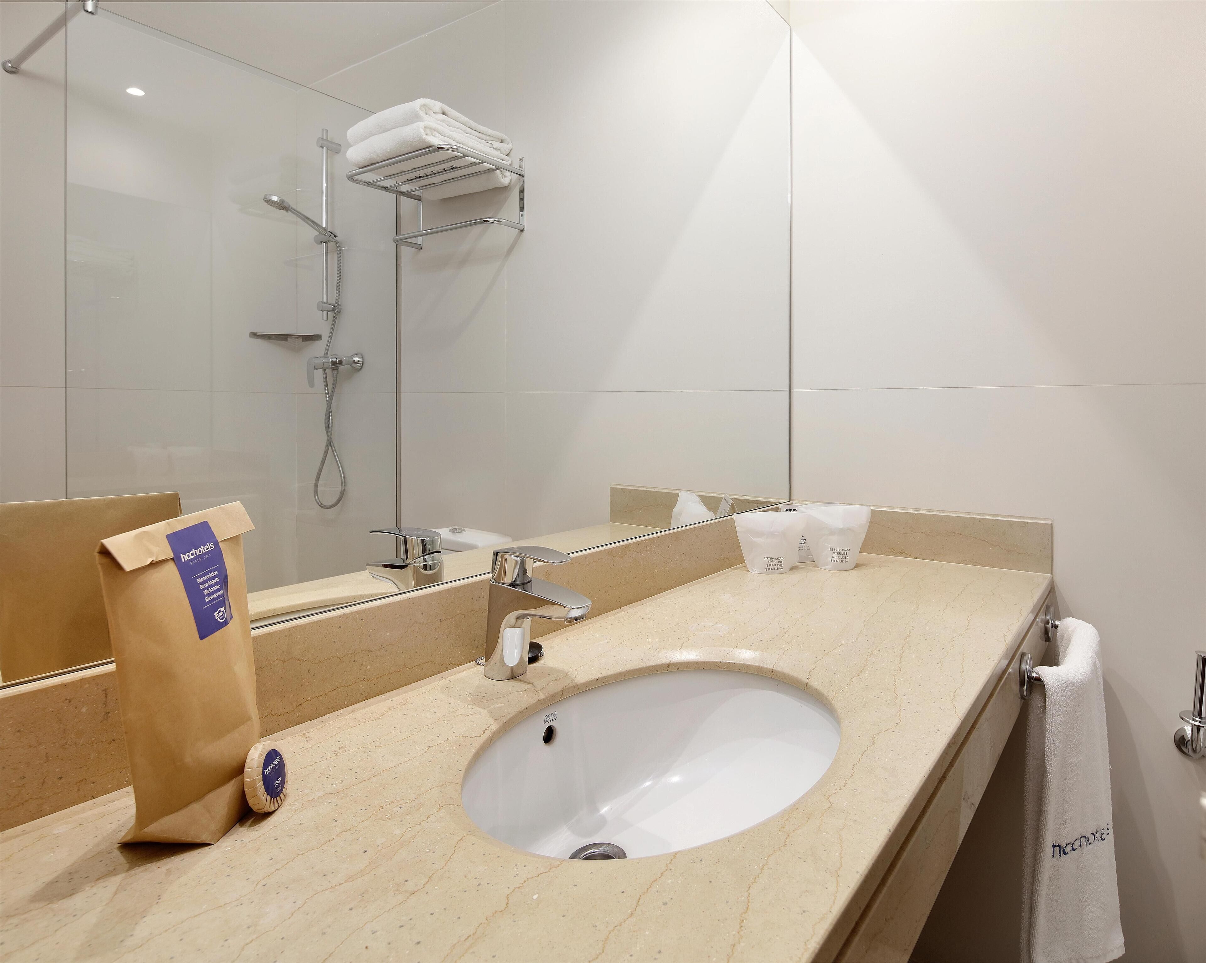 bathtub, eco-friendly toiletries, hair dryer, towels