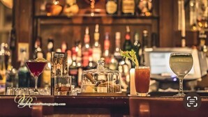 A bar with various bottles and glasses, including a martini, a whiskey bottle, and a cocktail with a garnish. - Abbey Hotel Roscommon (Roscommon)
