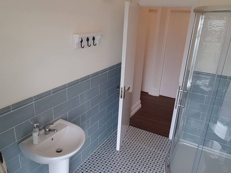 A bathroom with a sink, toilet, and shower.