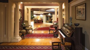 A grand lobby with a piano, red carpet, and classic furniture. - Castle Hotel Macroom (Macroom)