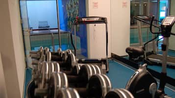 A gym with exercise equipment, including dumbbells and treadmills.