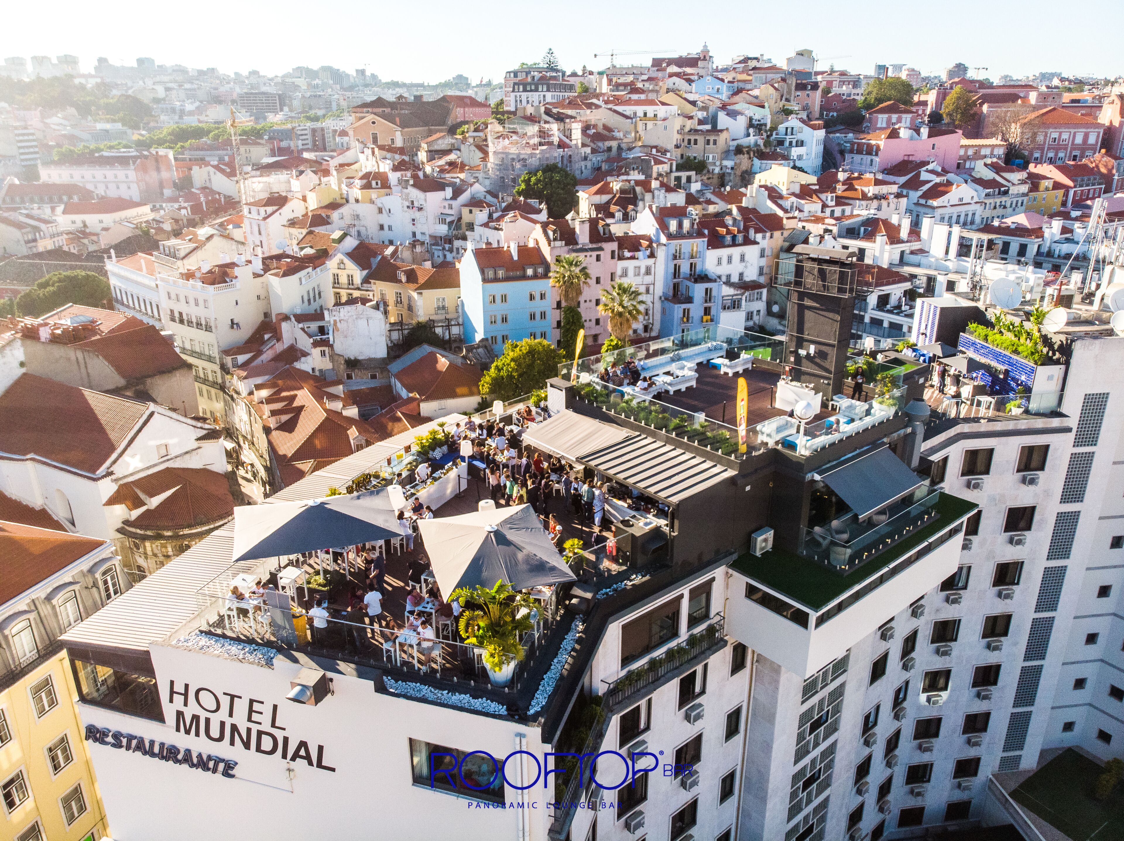 A rooftop bar with a view of the cityscape.