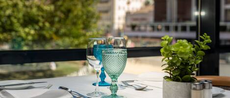 A table set for dining with a view of a cityscape.