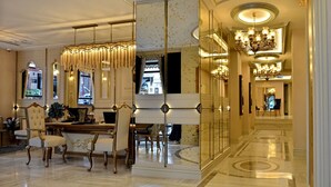A luxurious lobby with ornate chandeliers, a reception desk, and a seating area with upholstered chairs. - Romance Istanbul Hotel (Istanbul)