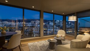 A modern living room with a city view, large windows, and contemporary furniture.