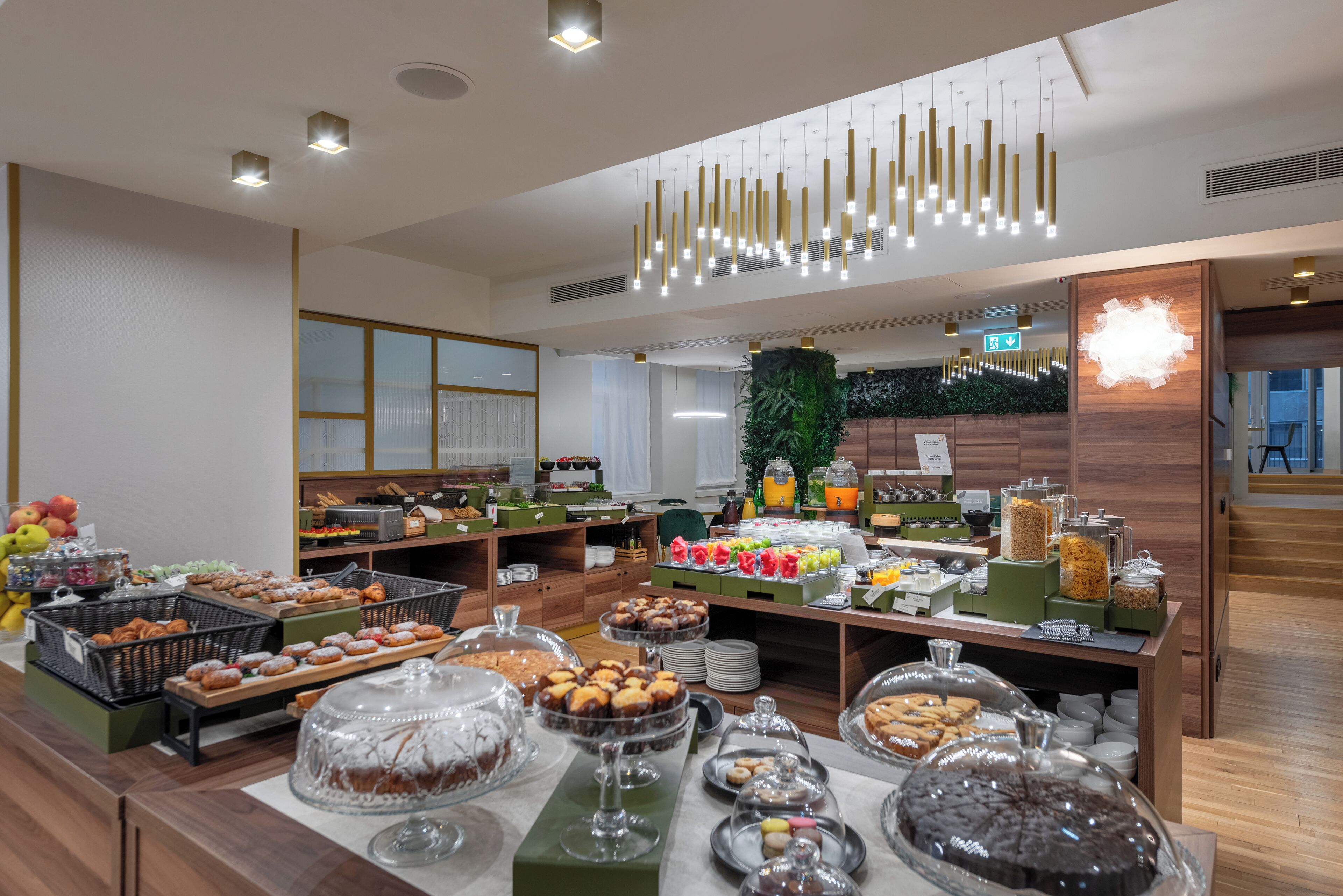 A buffet with various food items and a modern interior design.