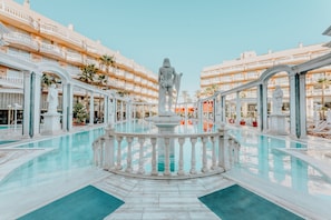 A luxurious hotel with a central pool, multiple balconies, and classical architecture. - Cleopatra Palace Hotel (Arona)