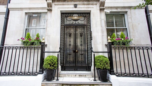 A historic building with a black wrought iron gate, a number '20' above the door, and flower boxes on either side. - Astor Court Hotel (London)