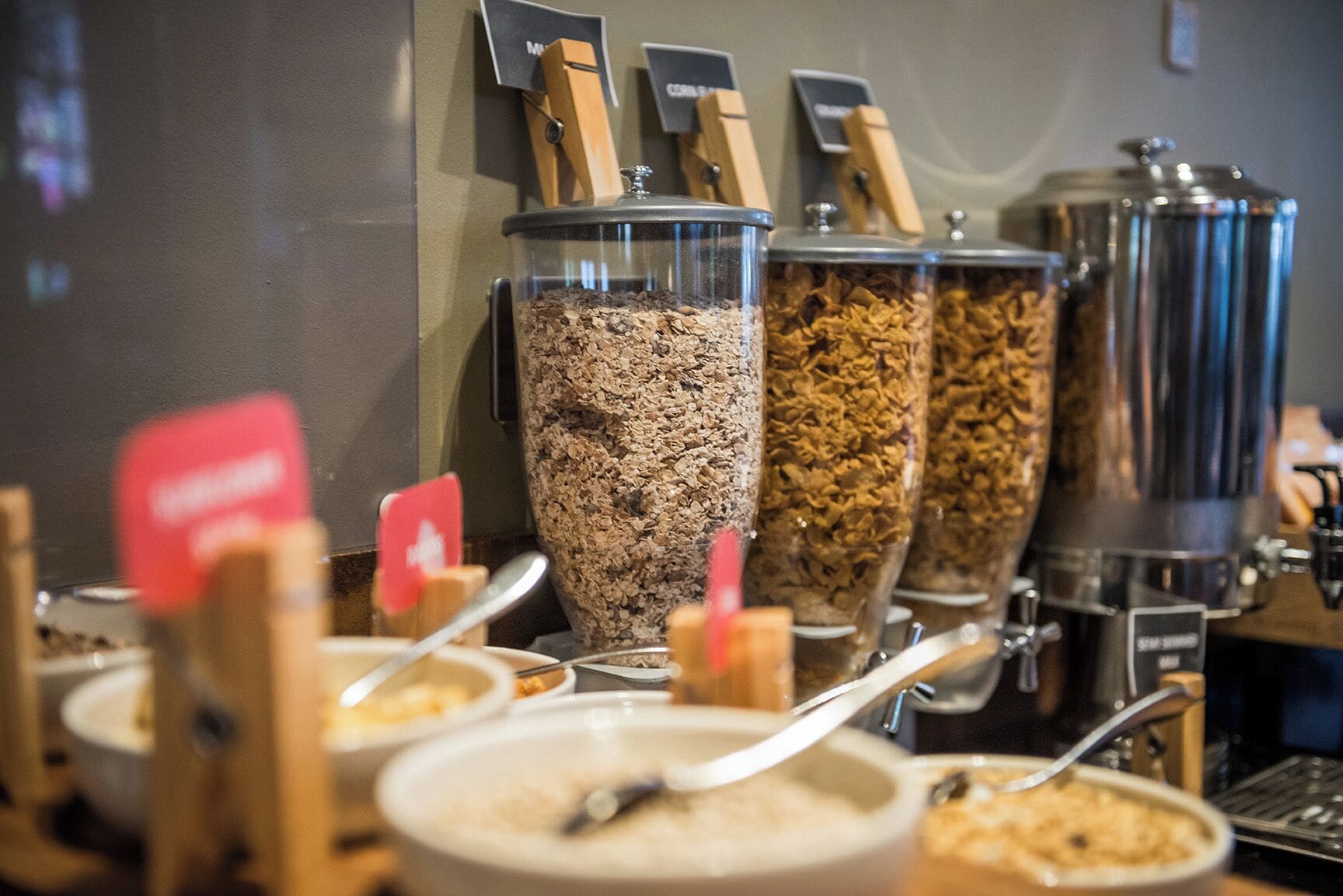 A buffet area with various food dispensers and serving utensils.