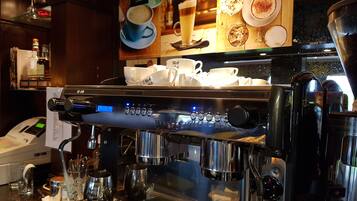 A coffee machine with multiple brewing options, a digital display, and a coffee cup holder.