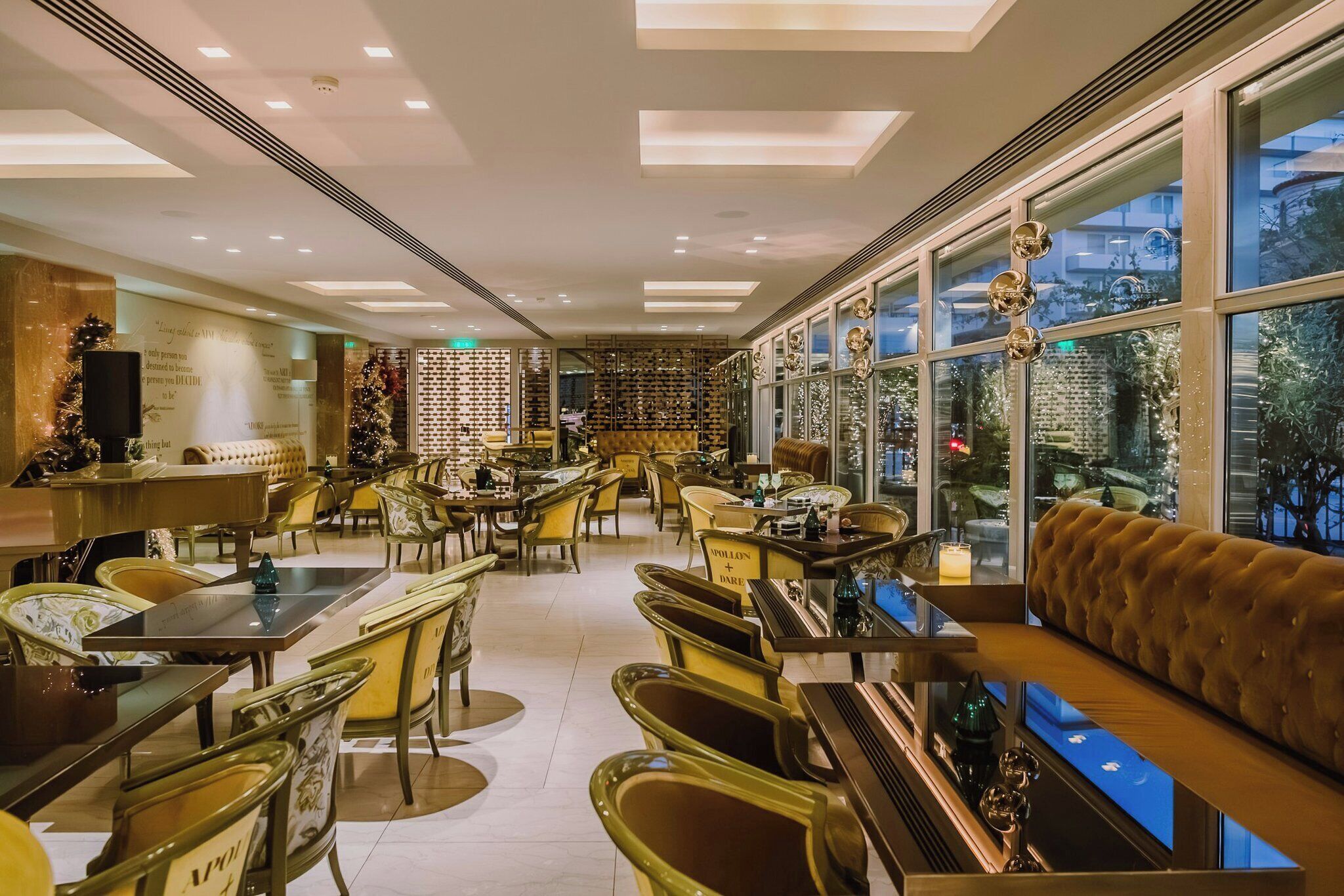 A restaurant with a modern interior, featuring a mix of seating options including tables and a sofa.