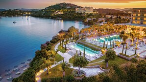 A resort with a large pool, beachfront, and a view of the water. - Corfu Imperial, A Resort to Live (Corfu)