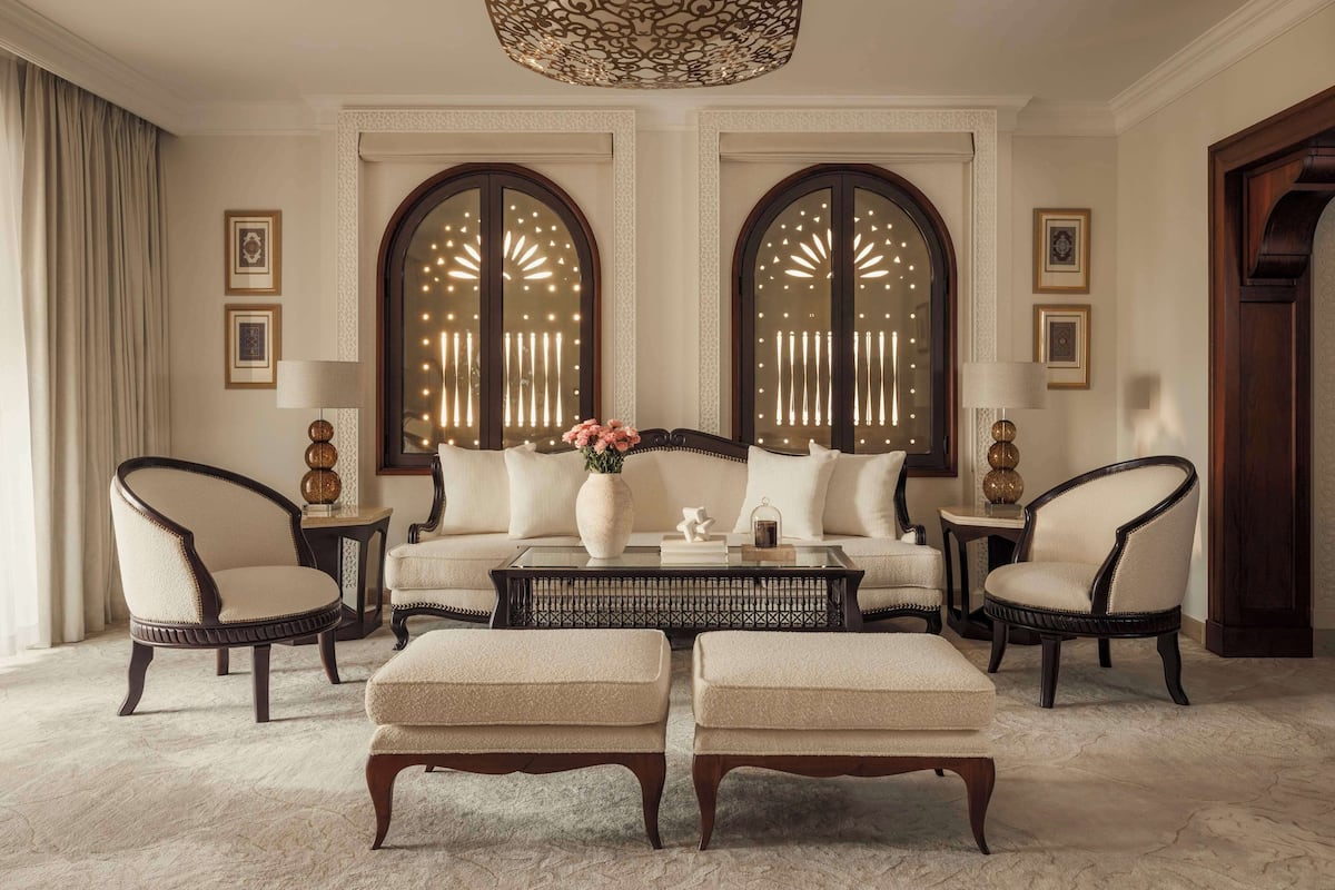 Ein luxuriöses Wohnzimmer mit einer Sofagarnitur, zwei Sesseln, einem Couchtisch und einer dekorativen Vase.