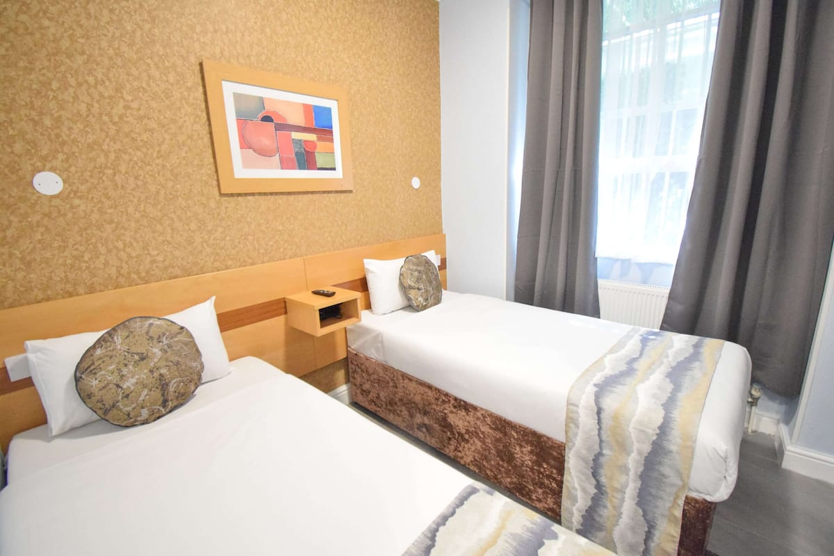 Twin Room | Minibar, blackout drapes, iron/ironing board, free WiFi