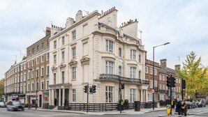 A historic building with multiple stories, large windows, and a prominent entrance. - Brunel Hotel (London)