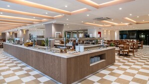 A modern dining area with a central buffet station, checkered flooring, and a clean, contemporary design. - Capsis Hotel Thessaloniki (Thessaloniki)