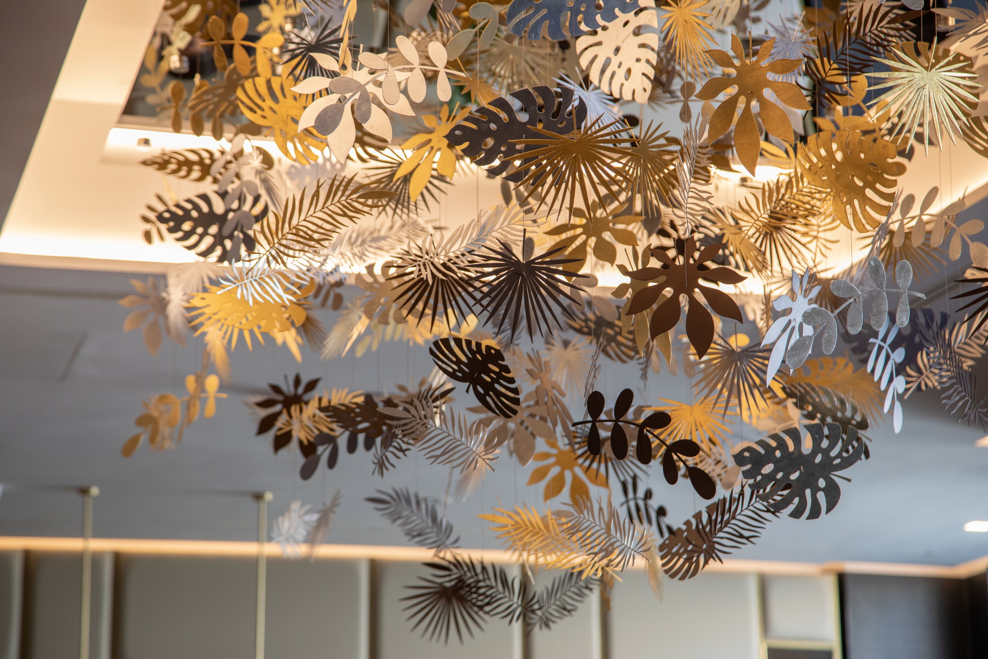 A ceiling with hanging paper art decorations.