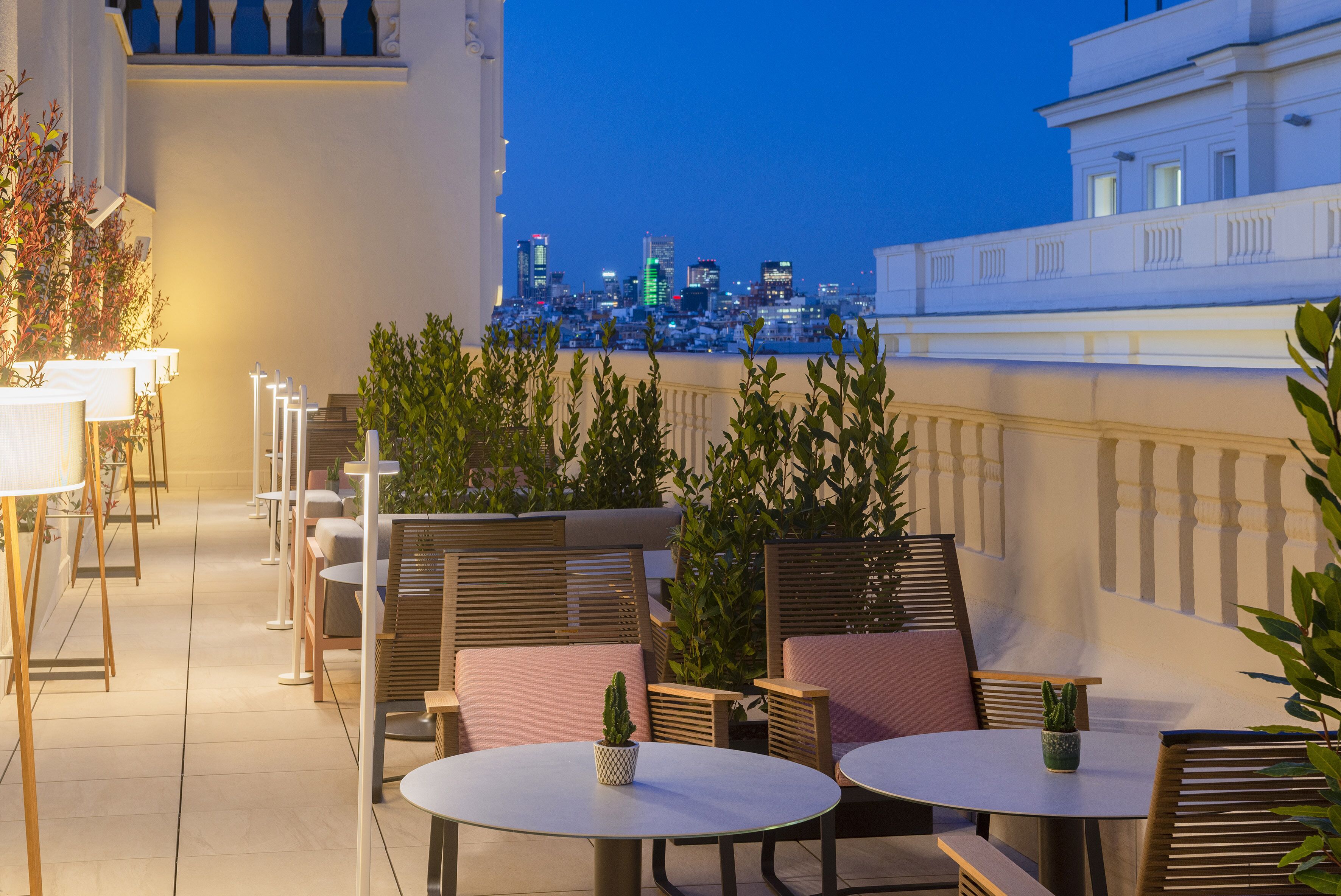 Terraza en la azotea con mobiliario exterior y vistas al horizonte urbano.