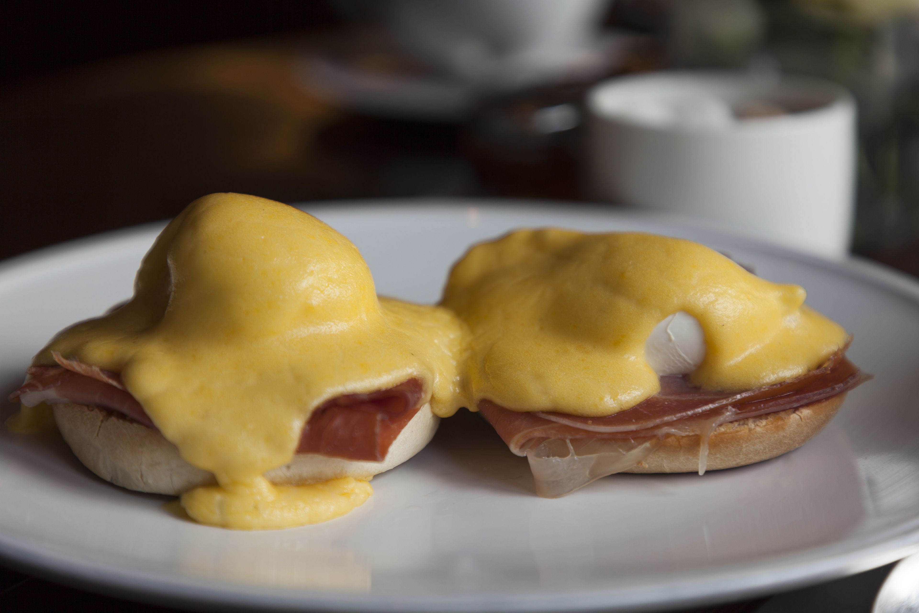A plate with two eggs benedict sandwiches.
