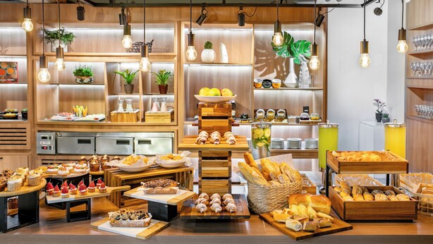 A buffet setup with various food items and a coffee station.