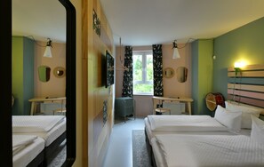 A bedroom with two beds, a mirror, a radiator, a desk with a chair, and a window with curtains. - Hotel BIRGIT Berlin Mitte (Berlin)
