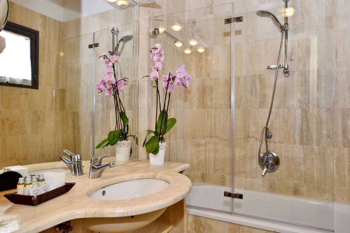 bathtub, rainfall showerhead, hair dryer, slippers