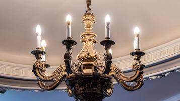 A chandelier with multiple candle-like lights and ornate decorations.