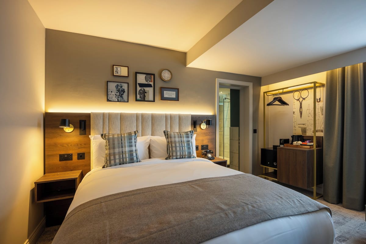 Premium bedding, desk, laptop workspace, iron/ironing board