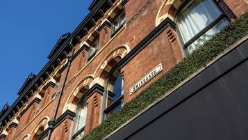 A brick building with arched windows and a sign reading "SWINGGATE."