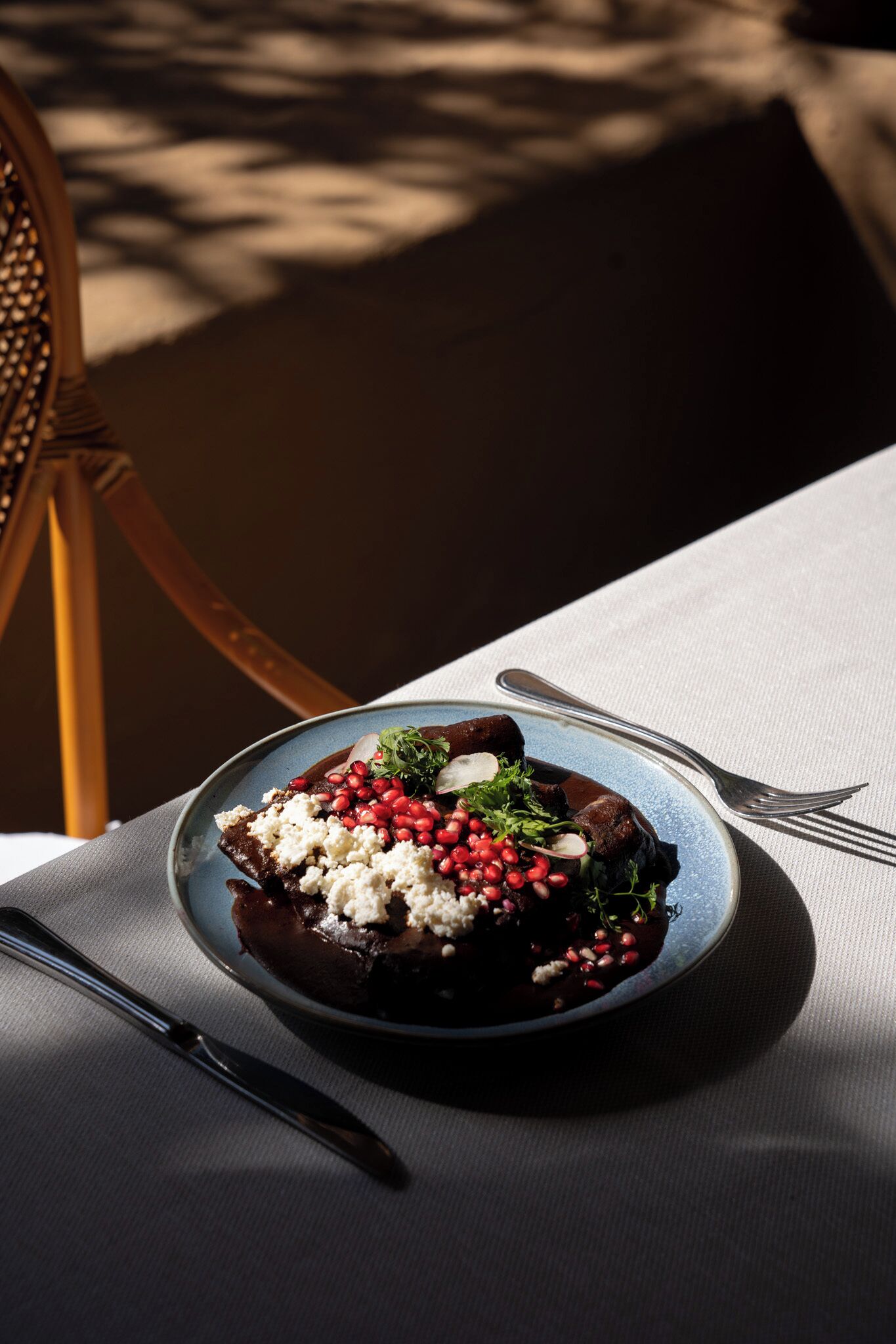 A plate of food on a table with a fork and knife beside it.