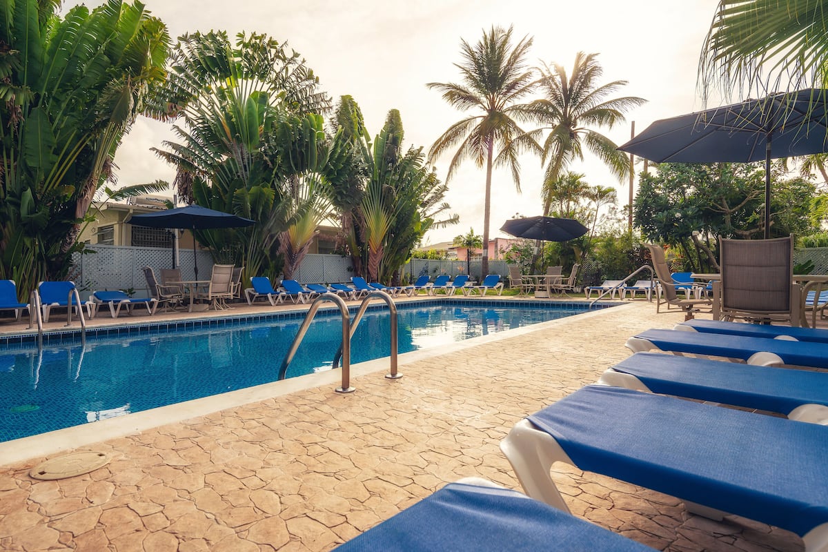 Room, Pool View (2 Double Beds) | In-room safe, desk, iron/ironing board, cribs/infant beds