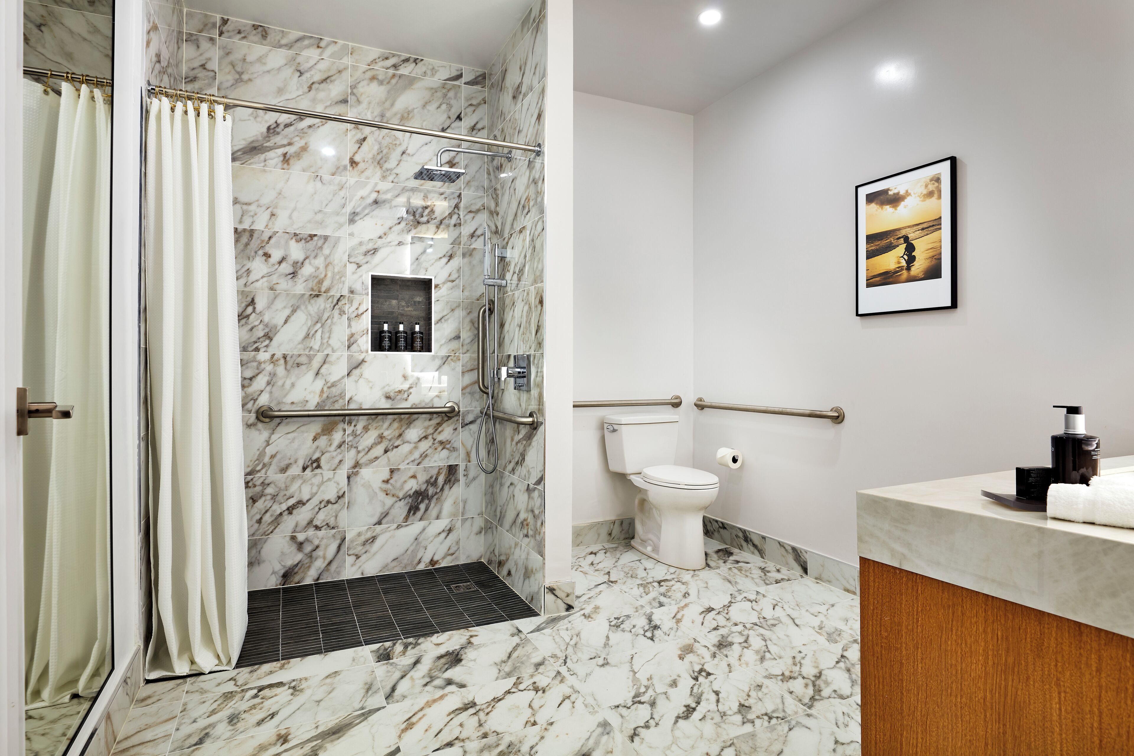 combined shower/bathtub, designer toiletries, hair dryer, bathrobes