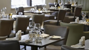 A restaurant with tables set for dining, including plates, cutlery, and glasses. - Best Western Ship Hotel (Weybridge)