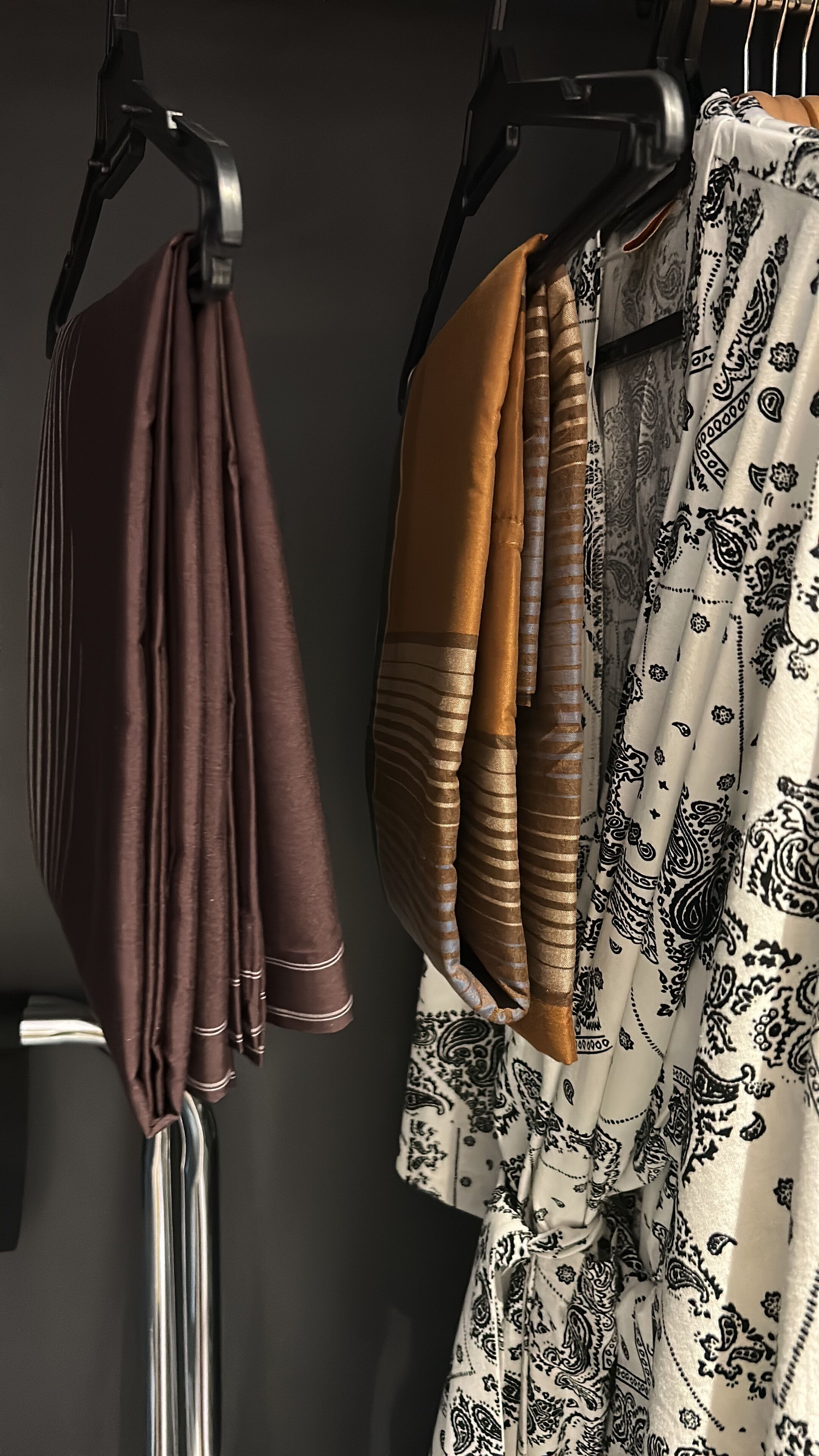 A rack with folded towels in various colors.