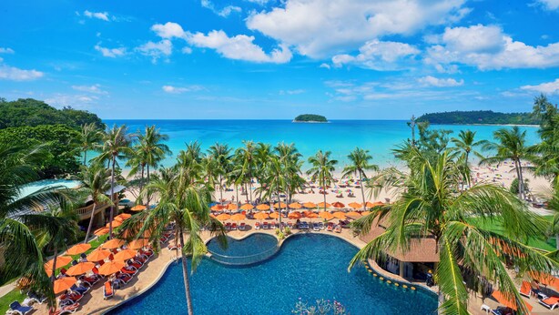 A resort with a swimming pool, beach, and palm trees. - Beyond Kata (Karon)