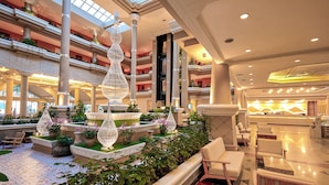 A spacious atrium with a central water feature, multiple levels, and seating areas. - Beyond Kata (Karon)