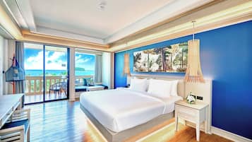 A hotel room with a large bed, a desk, and a view of the ocean through the balcony doors.
