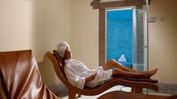 Relax in a serene spa area with a large shower and comfortable seating.