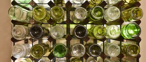 A wall of empty wine bottles arranged in a grid pattern.