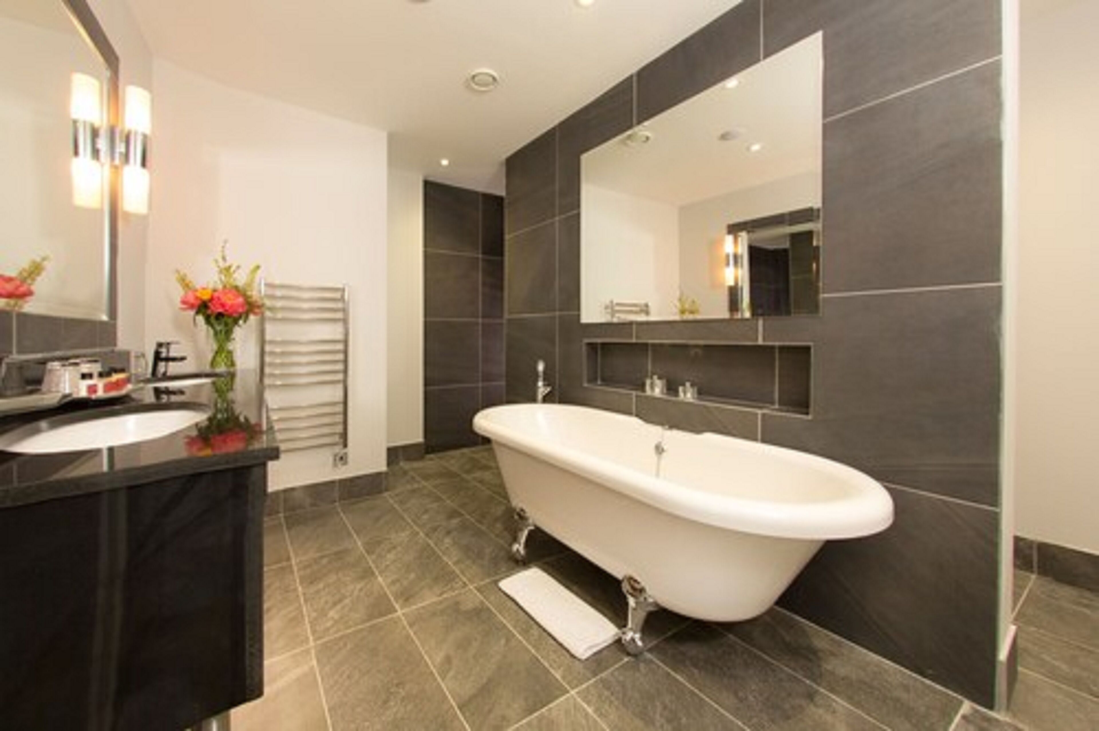 four poster suite lake view | bathroom | designer toiletries, hair dryer, towels, toilet paper