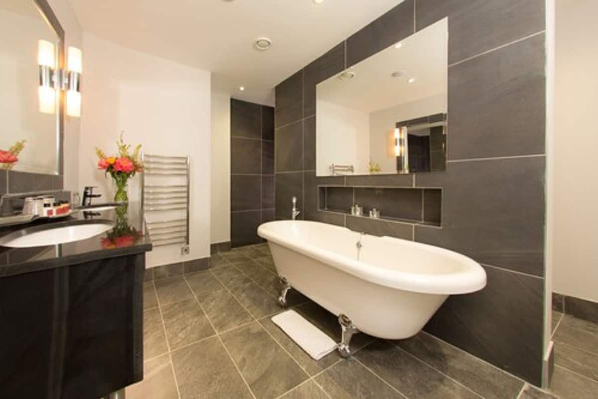 four poster suite lake view | bathroom | designer toiletries, hair dryer, towels, toilet paper