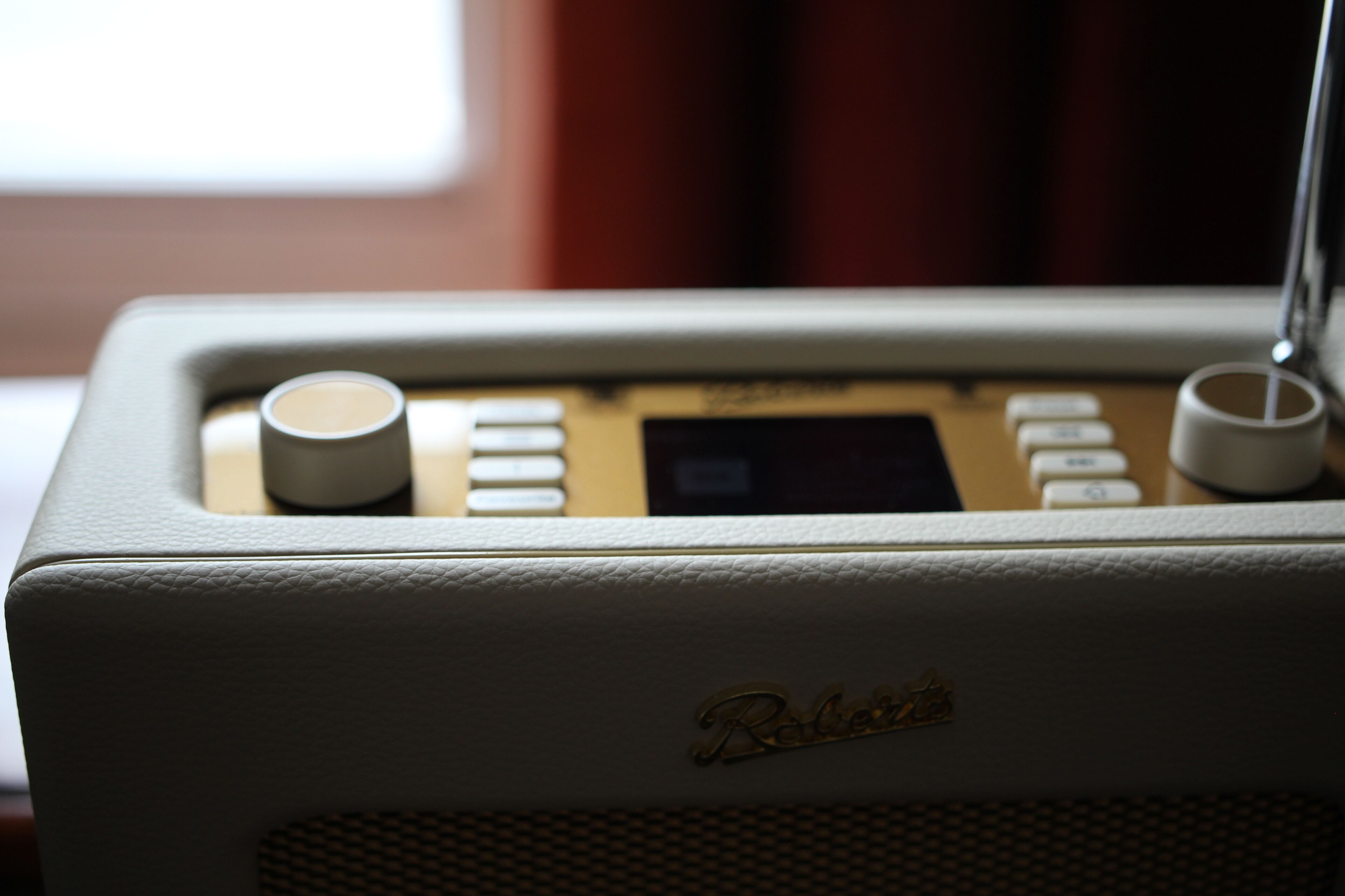 A vintage radio with a speaker grille and control buttons.