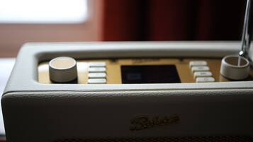 A vintage radio with a speaker grille and control buttons.