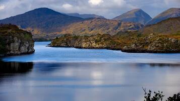 A calm lake surrounded by rugged mountains.