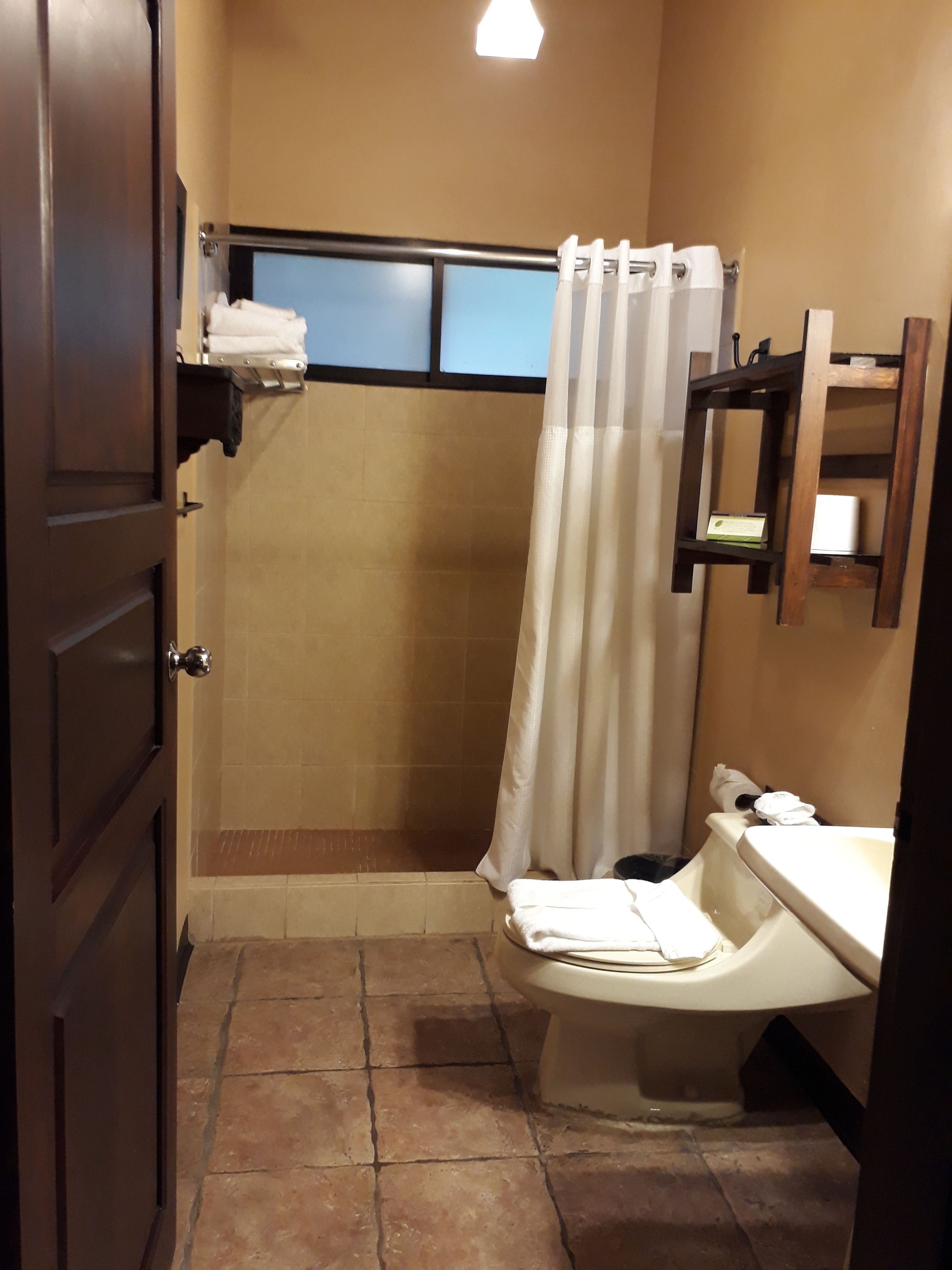 Un baño con ducha, inodoro y lavamanos.