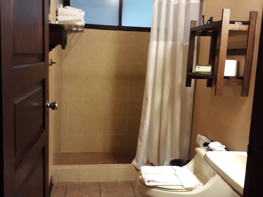 Un baño con ducha, inodoro y lavamanos.