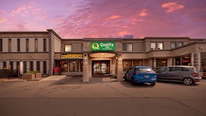 A hotel with a sign reading "Quality by Choice Hotel" and "Convenience" on the facade. - Quality Inn Toronto Airport (Mississauga)