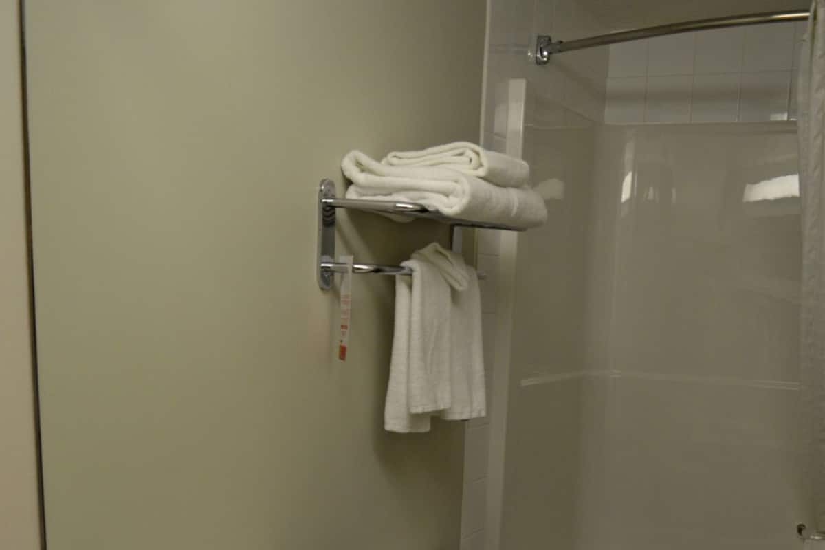 A bathroom with a toilet, a sink, and a glass shower enclosure.
